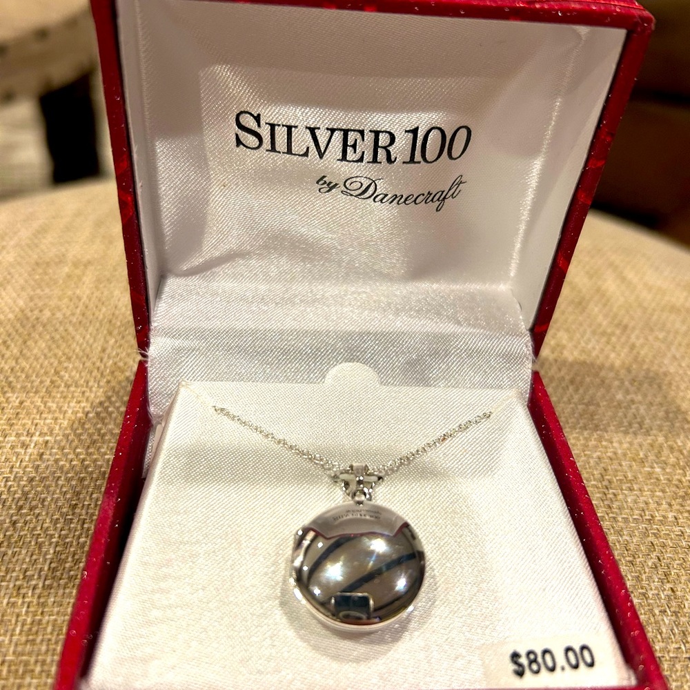 Silver plated locket, new in box.
